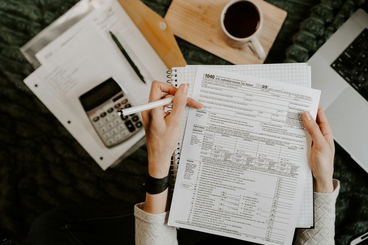 Reviewing financial documents with a calculator